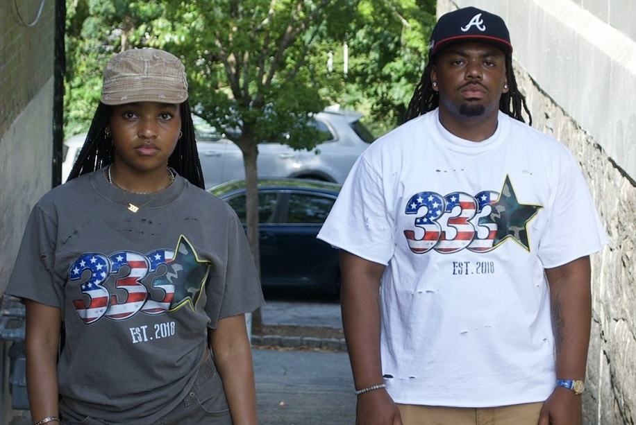 Portrait of two wearers in 333 Est. 2018 tees